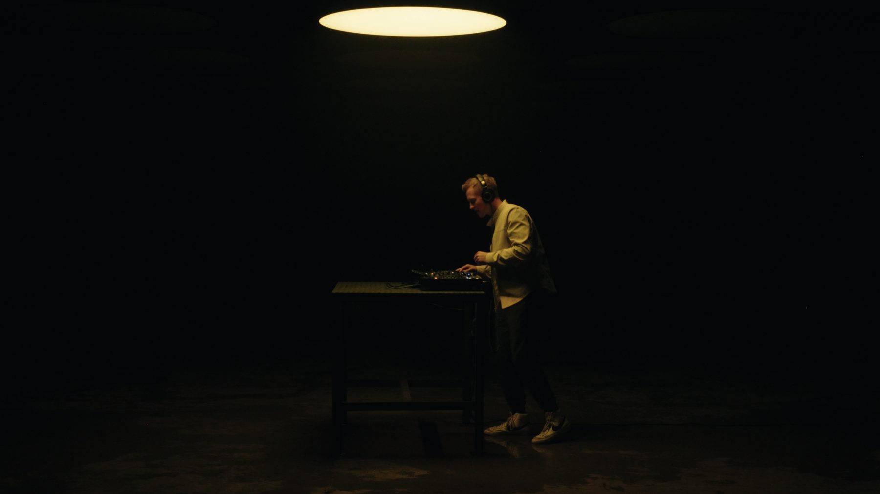 DJing under a single overhead light